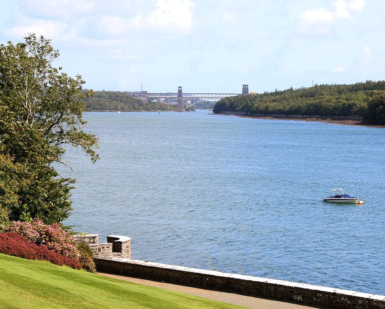 Plas Newydd seen from the south lawn — the house and garden slope above the Menai Strait.